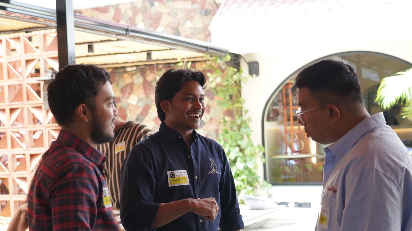 Ambarish laughing with a founder at a Bengaluru meetup