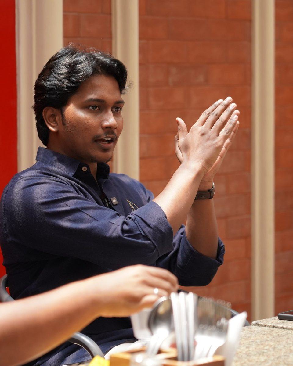 Ambarish Essetty mid-conversation at a founders' meetup in Bengaluru, 2026